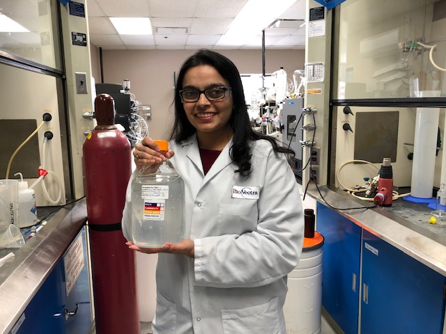 Zahra Merchant, pharmaceutical formulation scientist, holding BioVectra’s gel sanitizer
